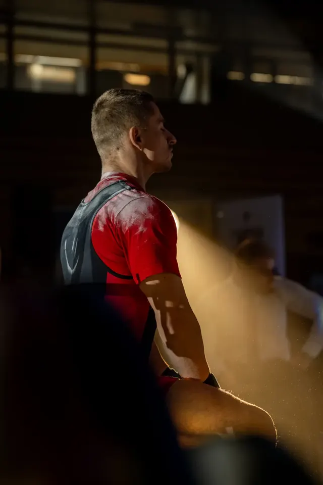 Atlét v bench drese počas prípravy na pokus